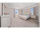 Calming main bedroom featuring large windows, neutral tones, and plush carpeting for a comfortable retreat at 4590 Sw 99Th St, Ocala, FL 34476