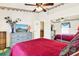 Comfortable bedroom featuring plush carpet, ceiling fan and a dresser with TV at 4721 Tara View Road, Leesburg, FL 34748
