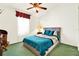 This bedroom is painted white, has a ceiling fan and a window at 4721 Tara View Road, Leesburg, FL 34748