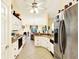 Bright eat-in kitchen featuring white cabinets, stainless steel appliances, and an open floor plan at 4721 Tara View Road, Leesburg, FL 34748