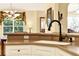 A close up shot of a kitchen featuring a sink with a modern faucet and views to dining area at 4721 Tara View Road, Leesburg, FL 34748