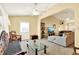 Cozy living room featuring plush seating, a ceiling fan, and ample natural light at 4721 Tara View Road, Leesburg, FL 34748