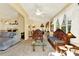 Inviting living room with decorative wood furniture, neutral walls, and plush carpeting at 4721 Tara View Road, Leesburg, FL 34748