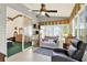 This sunroom is surrounded by windows, and features a couch, a chair, and decorative shelving at 4721 Tara View Road, Leesburg, FL 34748