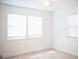 Bedroom with tile flooring, two bright windows, and a ceiling fan with light at 4840 Transport Rd, Bartow, FL 33830