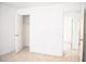 Bedroom with light tile flooring, a closet, doors leading to additional rooms, and white trim at 4840 Transport Rd, Bartow, FL 33830