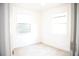 Bedroom featuring light tile flooring, bright windows, and white walls at 4840 Transport Rd, Bartow, FL 33830
