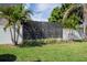 The backyard has a decorative metal and solid white privacy fence, providing a serene outdoor space at 5006 Legacy Oaks Dr, Orlando, FL 32839