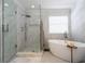 Luxurious bathroom with walk-in shower, soaking tub, and elegant fixtures at 5006 Legacy Oaks Dr, Orlando, FL 32839
