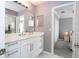 Light bathroom with a modern vanity, bright mirror, and access to the primary bedroom and walk-in closet at 5006 Legacy Oaks Dr, Orlando, FL 32839