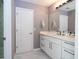 Elegant bathroom with white marble floors and sleek vanity with a big mirror at 5006 Legacy Oaks Dr, Orlando, FL 32839