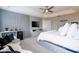 Spacious main bedroom with cozy white seating, and a sleek gray wall with an entertainment center at 5006 Legacy Oaks Dr, Orlando, FL 32839