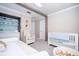 Charming Bedroom featuring a crib, changing table, and cozy armchair at 5006 Legacy Oaks Dr, Orlando, FL 32839