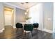 Stylish dining area with modern chandelier, round table, green velvet chairs, and hardwood floors at 5006 Legacy Oaks Dr, Orlando, FL 32839