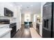 Sleek kitchen boasts stainless steel appliances, white cabinets, and a seamless flow to the dining space at 5006 Legacy Oaks Dr, Orlando, FL 32839