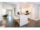 Bright kitchen featuring white cabinets, a quartz countertop island, hardwood floors, and stainless appliances at 5006 Legacy Oaks Dr, Orlando, FL 32839