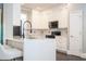 Bright kitchen featuring white cabinets, quartz countertop island, hardwood floors, and stainless appliances at 5006 Legacy Oaks Dr, Orlando, FL 32839