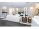 Elegant living room featuring modern decor, a large TV, recessed lighting, and stylish furniture at 5006 Legacy Oaks Dr, Orlando, FL 32839
