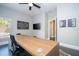 Modern office space with a large desk, dark floors, and minimalist decor at 5006 Legacy Oaks Dr, Orlando, FL 32839