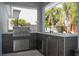 Outdoor kitchen area featuring a built-in grill, countertop space, and stainless steel storage at 5006 Legacy Oaks Dr, Orlando, FL 32839