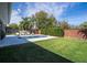 A beautiful backyard pool area with a pristine pool, lounge chairs, and manicured lawn at 5006 Legacy Oaks Dr, Orlando, FL 32839