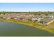 Aerial view showcasing homes in a lakeside community, featuring well-maintained lawns and direct water access at 5058 Sparkling Water Way, Kissimmee, FL 34746