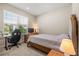 Cozy bedroom featuring plush carpet, a computer, a TV, and natural light from the large window at 5058 Sparkling Water Way, Kissimmee, FL 34746