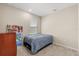 Simple bedroom with plush carpet, a window for natural light, and a comfortable twin bed at 5058 Sparkling Water Way, Kissimmee, FL 34746