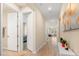 Hallway with tile flooring leads to a living room and multiple bedrooms at 5058 Sparkling Water Way, Kissimmee, FL 34746