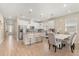 Bright kitchen with white cabinets, stainless steel appliances, bar stool seating and an adjacent dining area at 5058 Sparkling Water Way, Kissimmee, FL 34746