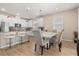 Bright kitchen with white cabinets, stainless steel appliances, bar stool seating and an adjacent dining area at 5058 Sparkling Water Way, Kissimmee, FL 34746
