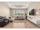 Bright living room features tile flooring, a tray ceiling, neutral paint and large windows for natural light at 5058 Sparkling Water Way, Kissimmee, FL 34746