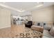 Open-concept living room and kitchen with stainless steel appliances, bar stool seating and a dining area at 5058 Sparkling Water Way, Kissimmee, FL 34746