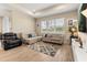 Bright living room features tile flooring, a tray ceiling, neutral paint and large windows overlooking a pond at 5058 Sparkling Water Way, Kissimmee, FL 34746
