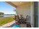 Relaxing covered patio with lake view, featuring outdoor furniture and a decorative 