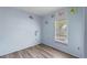 Bedroom with new flooring and a window with blinds at 519 Pearl St, Mascotte, FL 34753