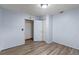 Bedroom with new flooring and two doorways at 519 Pearl St, Mascotte, FL 34753