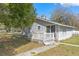 Exterior view of home with sliding glass door and porch with railing at 519 Pearl St, Mascotte, FL 34753