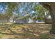 Exterior side view of home with mature trees and foliage at 519 Pearl St, Mascotte, FL 34753