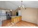 Kitchen with white cabinets, stainless steel refrigerator, and center island for seating at 519 Pearl St, Mascotte, FL 34753