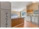 Open kitchen layout with white cabinets, island, gas range, and sliding door to the deck at 519 Pearl St, Mascotte, FL 34753
