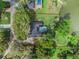 Aerial view of a property highlighting a pool, lake access, and surrounding trees at 598 Palm Dr, Oviedo, FL 32765