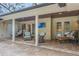 Inviting covered patio with tiled flooring, ceiling fans, outdoor seating, and a wall mounted TV at 598 Palm Dr, Oviedo, FL 32765