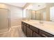 Well-lit bathroom featuring double sinks, stylish vanity, tiled floors, and a glass-enclosed shower at 6097 Monterey Cypress Trl, Sanford, FL 32773