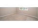 Bright bedroom with neutral walls and carpeting with a sunlit window at 6097 Monterey Cypress Trl, Sanford, FL 32773
