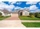 Inviting single-Gathering home with manicured lawn, two-car garage, and attractive landscaping at 6097 Monterey Cypress Trl, Sanford, FL 32773