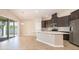 Open eat-in kitchen with stainless steel appliances, modern counters and access to the outdoor patio at 6097 Monterey Cypress Trl, Sanford, FL 32773