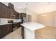 Modern kitchen with stainless steel appliances, ample cabinets, and a quartz countertop island at 6097 Monterey Cypress Trl, Sanford, FL 32773