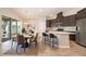 Modern eat-in kitchen with stainless steel appliances and access to the outdoor patio at 6097 Monterey Cypress Trl, Sanford, FL 32773