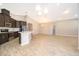 Spacious living room and kitchen with wood-look floors and vaulted ceilings at 6097 Monterey Cypress Trl, Sanford, FL 32773